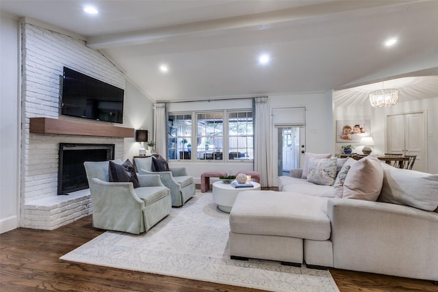 living room featuring lofted ceiling with beams, a fireplace, a chandelier, recessed lighting, and wood finished floors