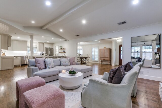 living room featuring lofted ceiling with beams, recessed lighting, wood finished floors, and visible vents
