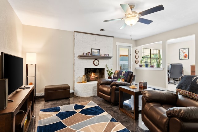 living area with baseboards, a ceiling fan, and a fireplace