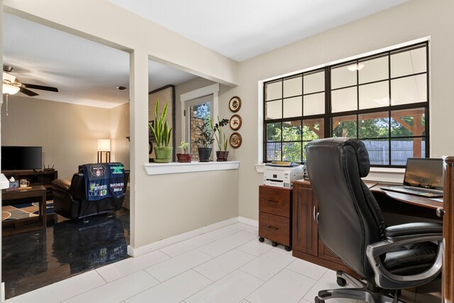 office area featuring light tile patterned flooring, ceiling fan, and baseboards