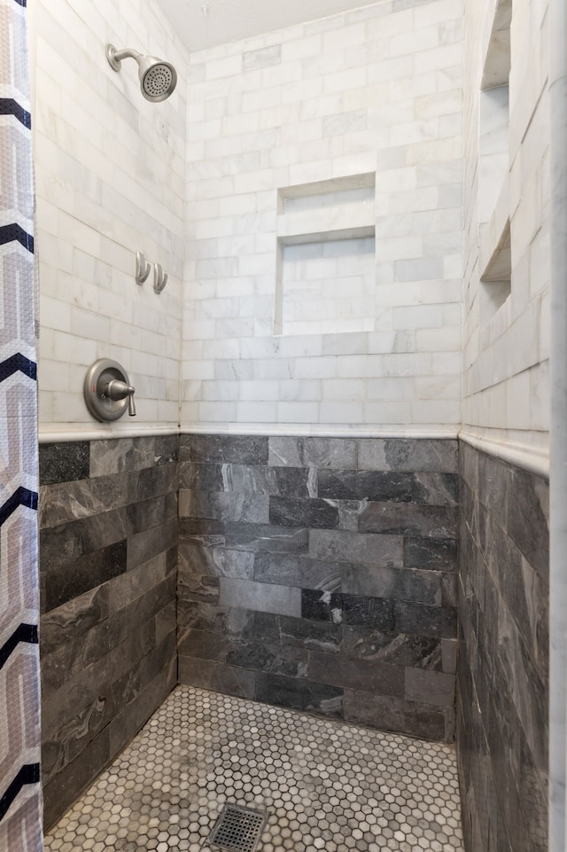 full bathroom with a tile shower