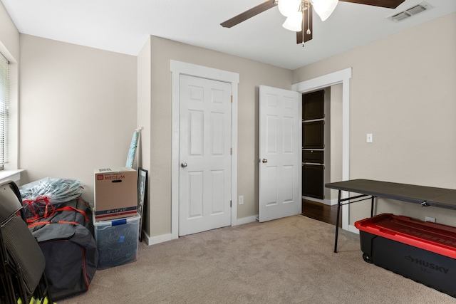 interior space featuring visible vents, baseboards, and ceiling fan