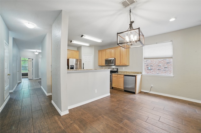 kitchen featuring visible vents, light brown cabinetry, baseboards, dark wood-type flooring, and stainless steel appliances