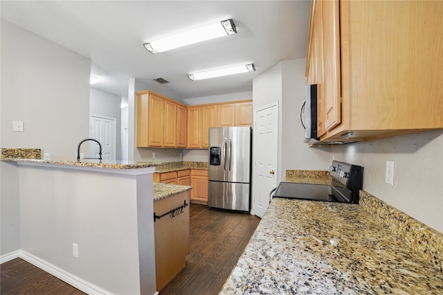 kitchen featuring dark wood-type flooring, appliances with stainless steel finishes, light brown cabinetry, and visible vents