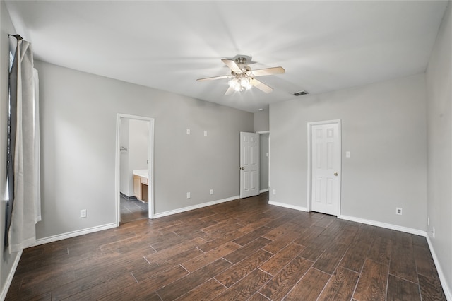 unfurnished bedroom featuring baseboards, dark wood-type flooring, and visible vents