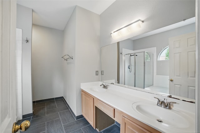 bathroom with a tub, double vanity, a shower stall, and a sink