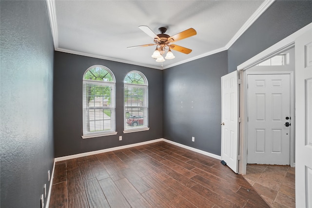 empty room with crown molding, a ceiling fan, baseboards, and wood finished floors