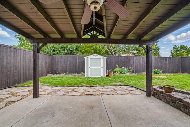 view of patio with an outdoor structure, a shed, and a fenced backyard