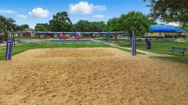 surrounding community featuring a yard, volleyball court, and playground community
