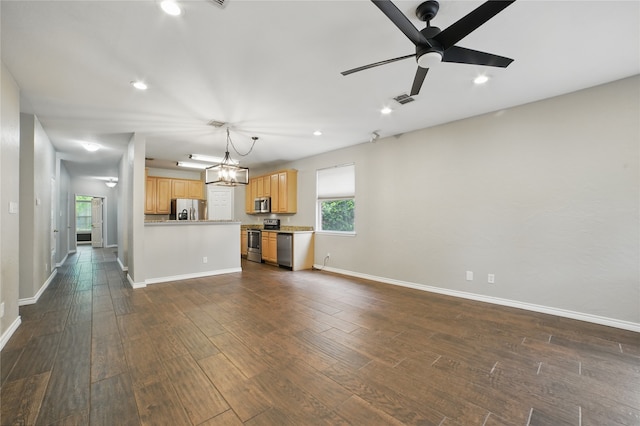 unfurnished living room with recessed lighting, baseboards, dark wood-style floors, and a wealth of natural light
