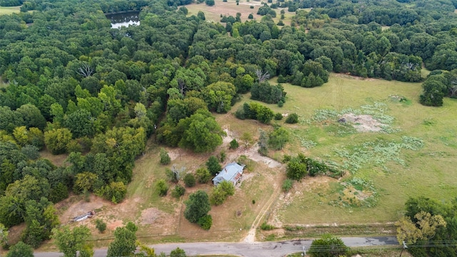 birds eye view of property featuring a view of trees and a rural view