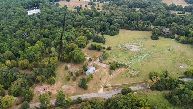 birds eye view of property with a view of trees