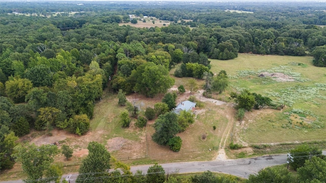 aerial view featuring a rural view and a wooded view