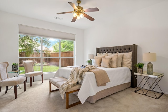 bedroom featuring ceiling fan, visible vents, and light carpet