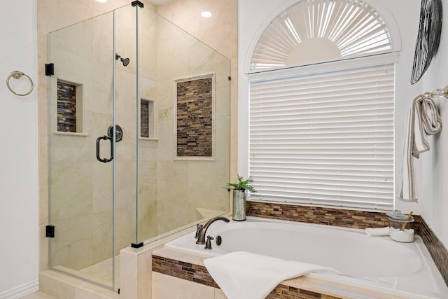 bathroom with a bath and a stall shower
