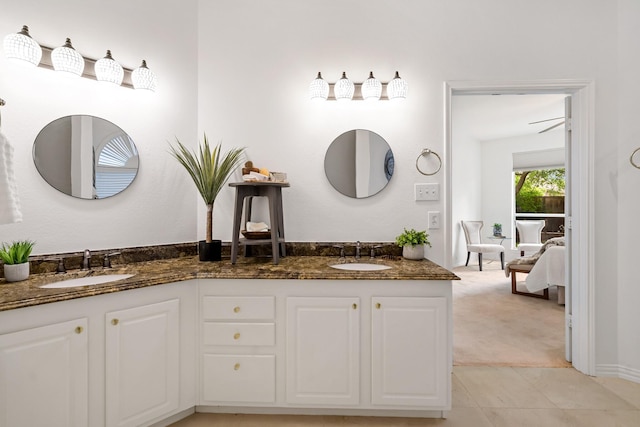 bathroom featuring a sink, ensuite bath, and double vanity