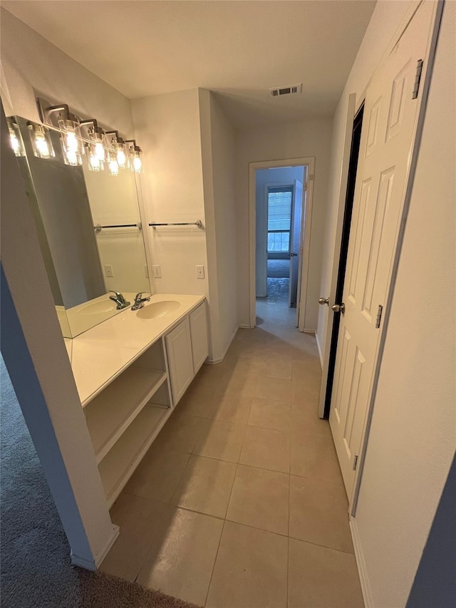 bathroom with tile patterned floors, visible vents, baseboards, and vanity