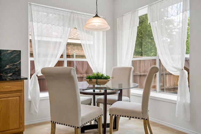dining room featuring baseboards and light tile patterned floors