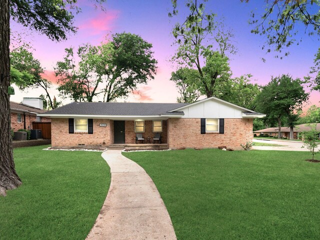 2009 Greenbriar Ln, Plano, TX 75074 - ranch-style house with brick siding, a lawn, and central AC unit
