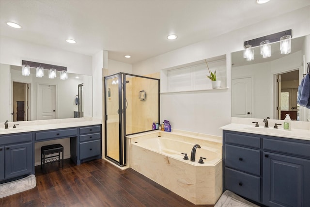 6510 Circo Dr, Granbury, TX 76049 - bathroom featuring a shower stall, a bath, wood finished floors, two vanities, and recessed lighting