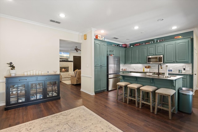 6510 Circo Dr, Granbury, TX 76049 - kitchen with stainless steel appliances, ornamental molding, dark wood finished floors, decorative backsplash, and recessed lighting