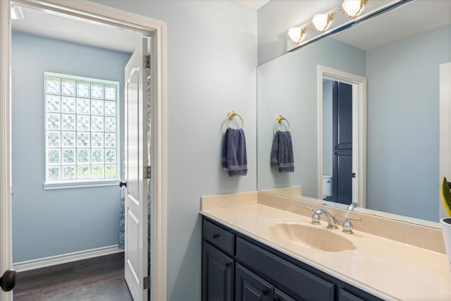 6510 Circo Dr, Granbury, TX 76049 - bathroom with vanity, wood finished floors, baseboards, and toilet