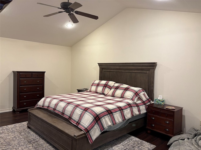 bedroom with vaulted ceiling, dark wood-type flooring, and ceiling fan