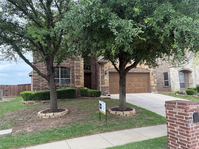 1121 Albany Dr, Fort Worth, TX 76131 - view of property hidden behind natural elements with brick siding, fence, driveway, and a garage