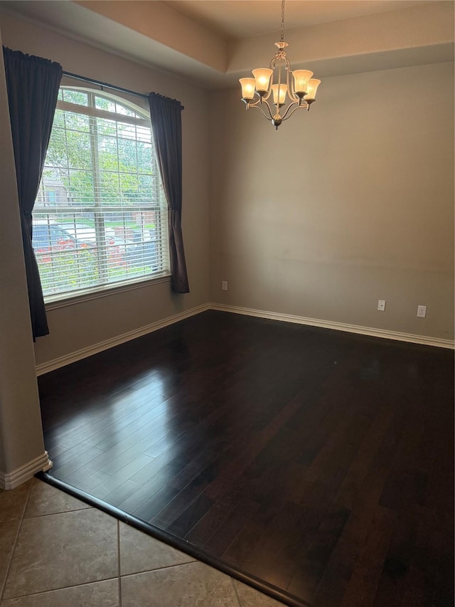1121 Albany Dr, Fort Worth, TX 76131 - empty room featuring an inviting chandelier, baseboards, wood finished floors, and a healthy amount of sunlight