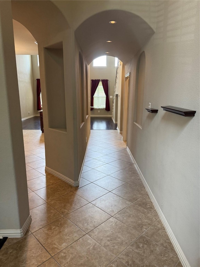 1121 Albany Dr, Fort Worth, TX 76131 - hallway with arched walkways, baseboards, and tile patterned floors