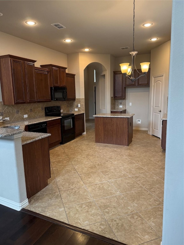 1121 Albany Dr, Fort Worth, TX 76131 - kitchen featuring dark brown cabinetry, black appliances, arched walkways, backsplash, and a notable chandelier