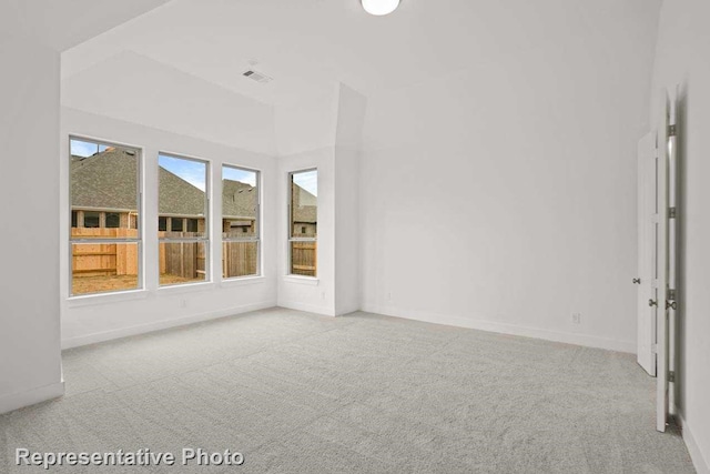 unfurnished room with carpet flooring, baseboards, and visible vents