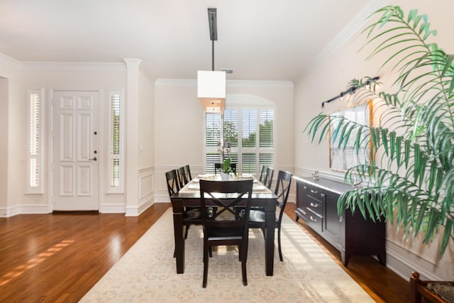dining area featuring crown molding and wood finished floors