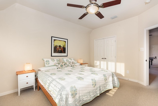 bedroom featuring a closet, baseboards, light colored carpet, and visible vents
