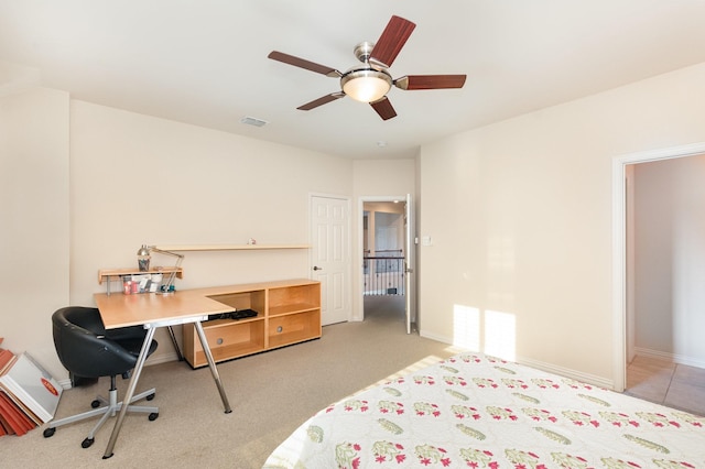 bedroom featuring visible vents, baseboards, ceiling fan, and light carpet