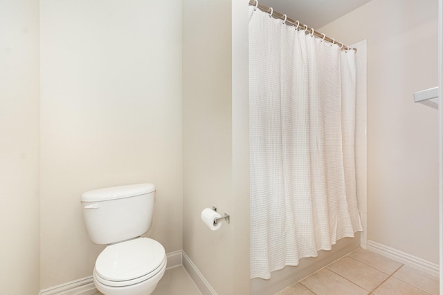 full bath featuring baseboards, tile patterned flooring, and toilet