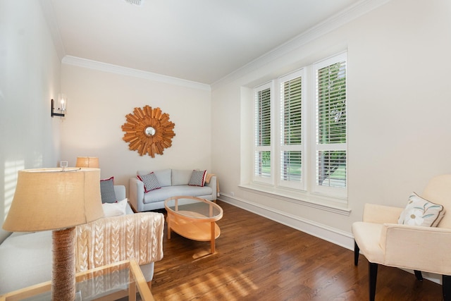living area with baseboards, ornamental molding, and wood finished floors