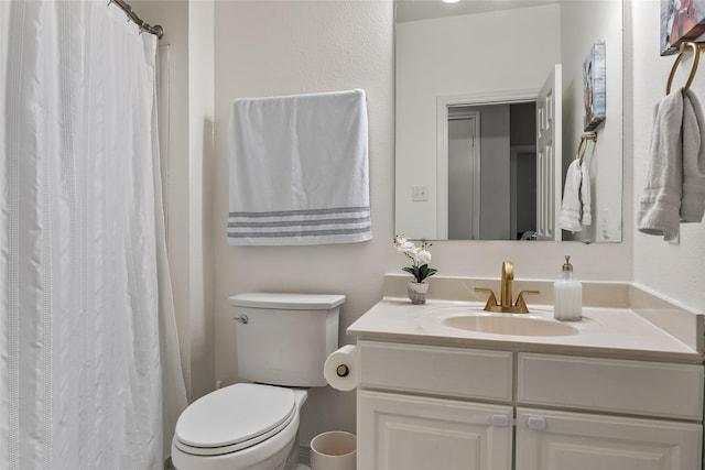 bathroom featuring toilet, a shower with curtain, and vanity