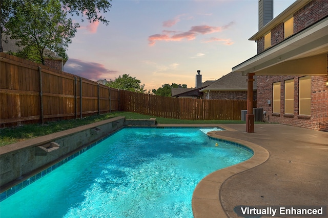 view of pool with a fenced backyard, a fenced in pool, a patio, and central AC unit
