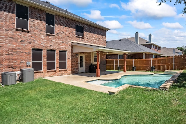 view of pool with central AC, fence, a fenced in pool, a patio area, and a yard