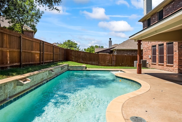 view of swimming pool with a patio, central AC, a fenced in pool, and a fenced backyard