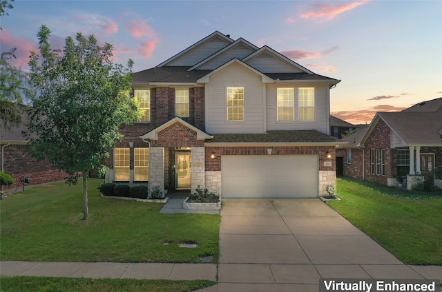 view of front of house featuring a garage, a yard, stone siding, and concrete driveway