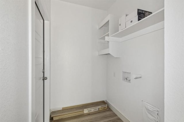 laundry area with laundry area, hookup for a washing machine, and wood finished floors