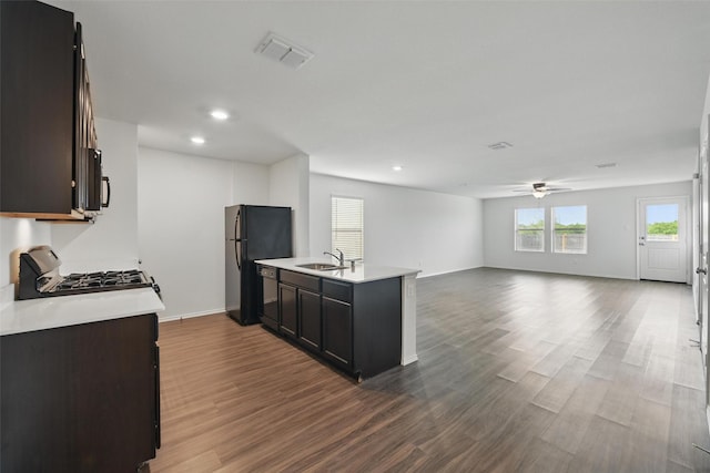 329 Blue Crow Ln, Fort Worth, TX 76052 - kitchen featuring ceiling fan, a sink, light countertops, dark wood-type flooring, and visible vents
