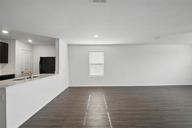 329 Blue Crow Ln, Fort Worth, TX 76052 - unfurnished living room with a sink, recessed lighting, baseboards, visible vents, and dark wood-style floors