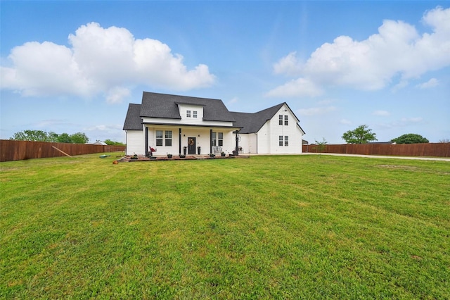 modern farmhouse style home featuring a fenced backyard and a front yard