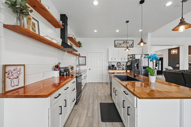 kitchen with open shelves, a sink, electric range oven, light wood-style floors, and wood counters