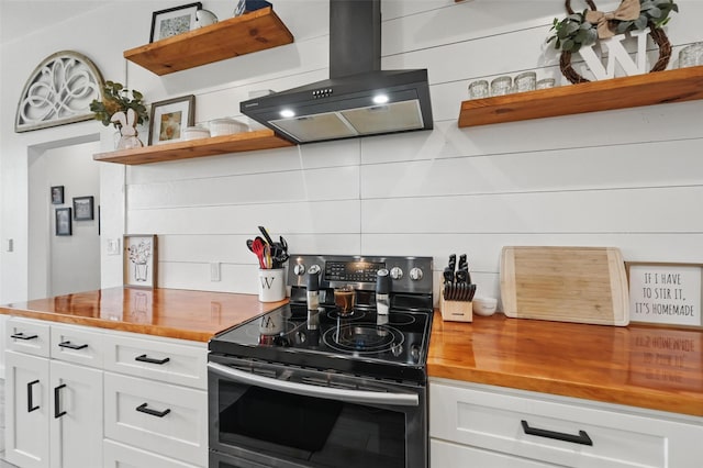 kitchen with open shelves, electric range, wooden counters, island range hood, and tasteful backsplash