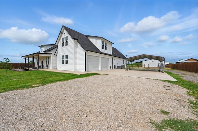 view of side of home featuring a yard, a carport, fence, concrete driveway, and a shingled roof