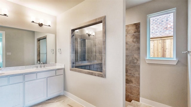 full bath with walk in shower, a sink, double vanity, marble finish floor, and baseboards
